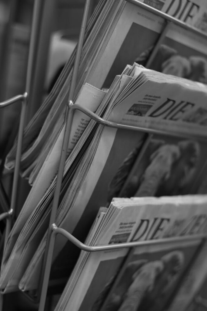 Newsletters Monochrome image of newspapers in a wire stand, capturing simplicity.